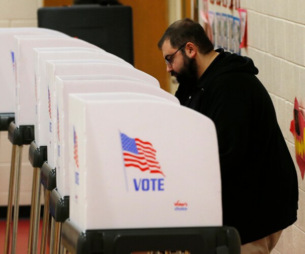 a voter fills out a ballot in richmond, virginia