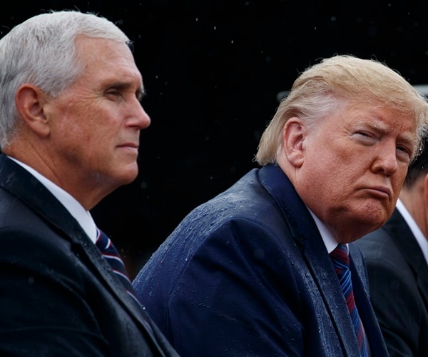 mike pence sits next to president donald trump