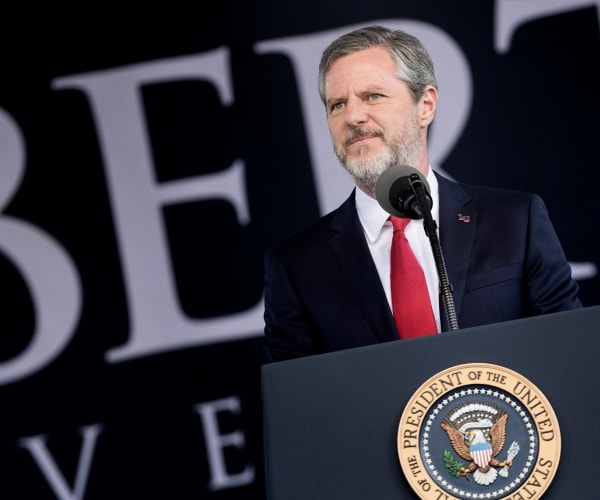 falwell in a black suit and red tie at liberty university