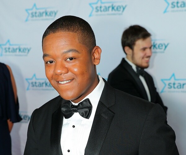 kyle massey stands on red carpet