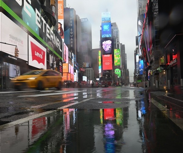 the empty streets and wet pavement of times square