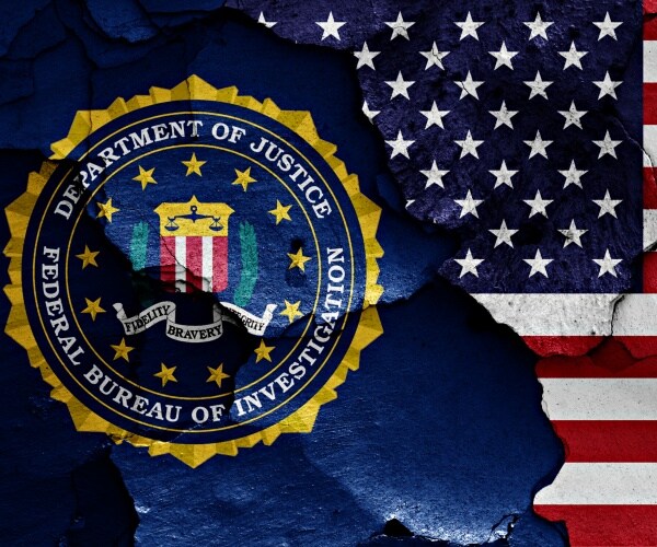 flag of fbi and us painted on cracked wall