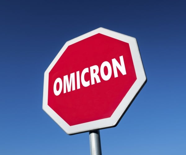 stop sign with "omicron" written on it