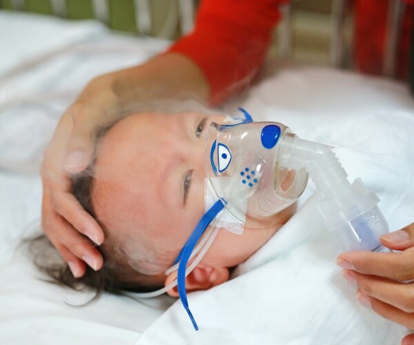 baby sick with RSV in hospital getting a nebulizer treatment