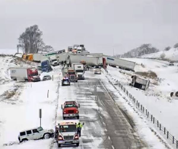 cars wrecked on a snowy highway