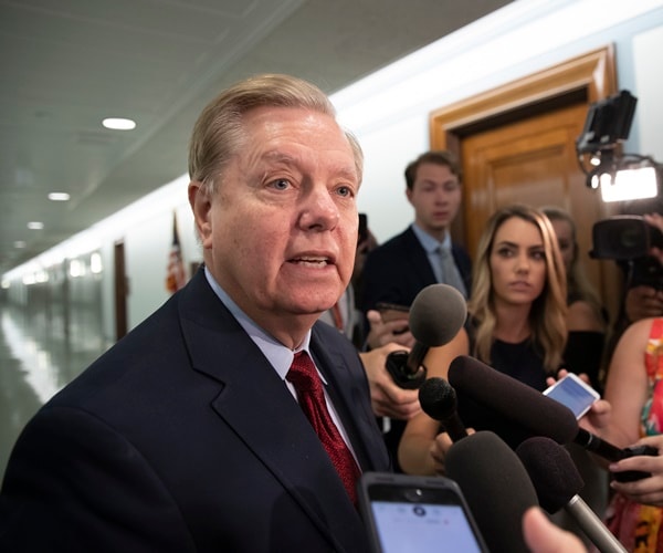 lindsey graham is interviewed by the press in the capitol