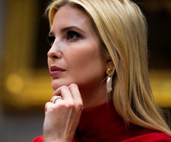 ivanka trump in a red turtleneck sweater and hand to her chin