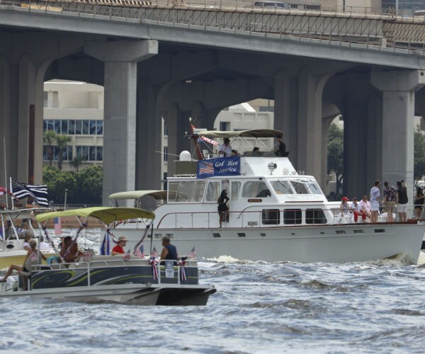 people are shown participating in two trump boat parades