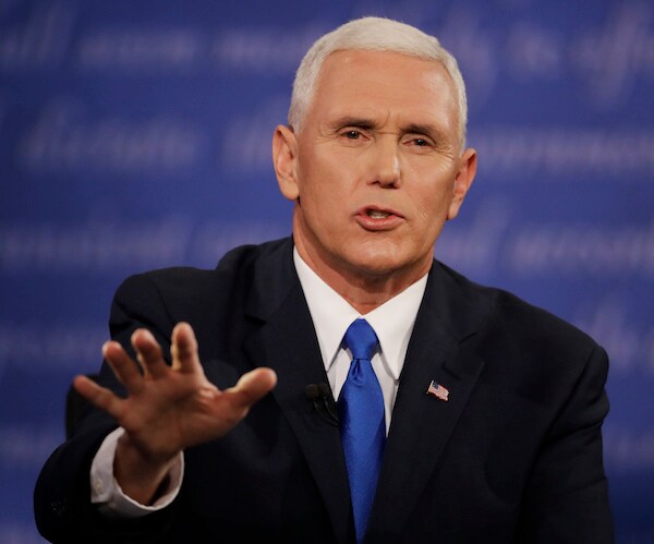 vice president mike pence gestures with his right hand palm out and facing the table while delivering remarks