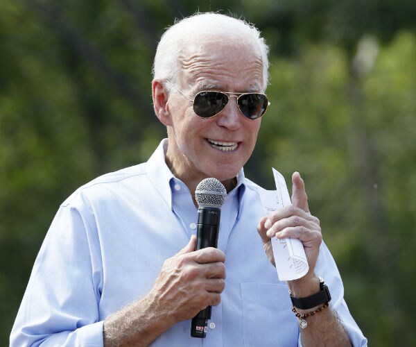 joe biden speaking and pointing while holding a microphone