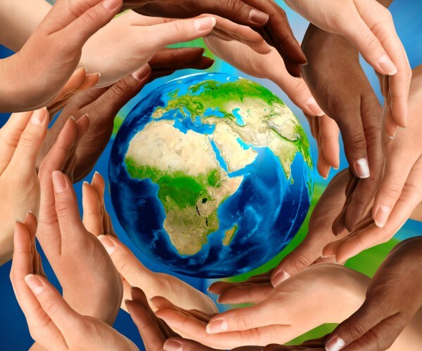 the earth surrounded by peoples hands