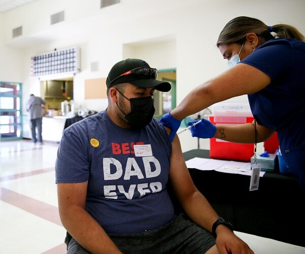 man receives coronavirus vaccine shot