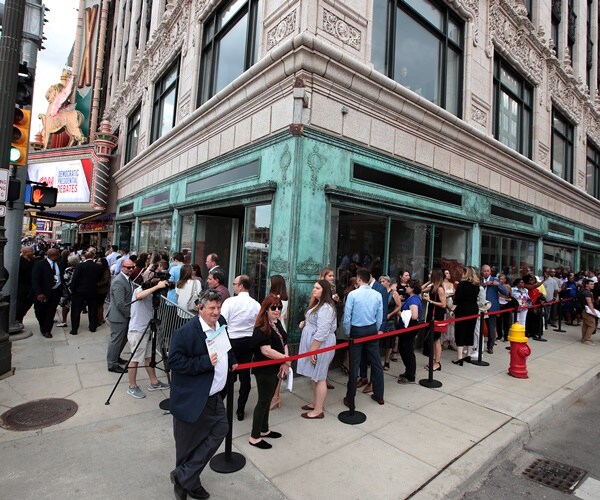 a line of people outside the fox theater in downtown detroit