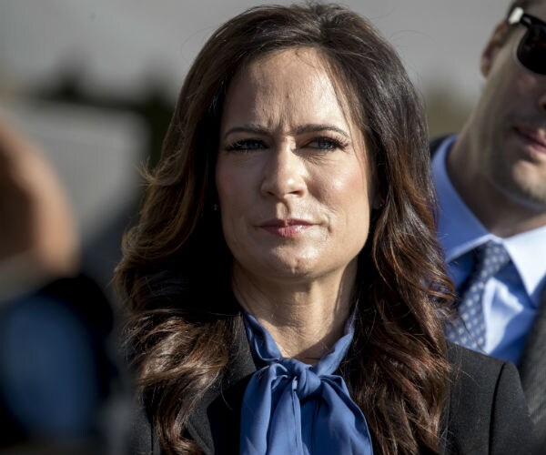 White House press secretary Stephanie Grisham is shown in a blue blouse.