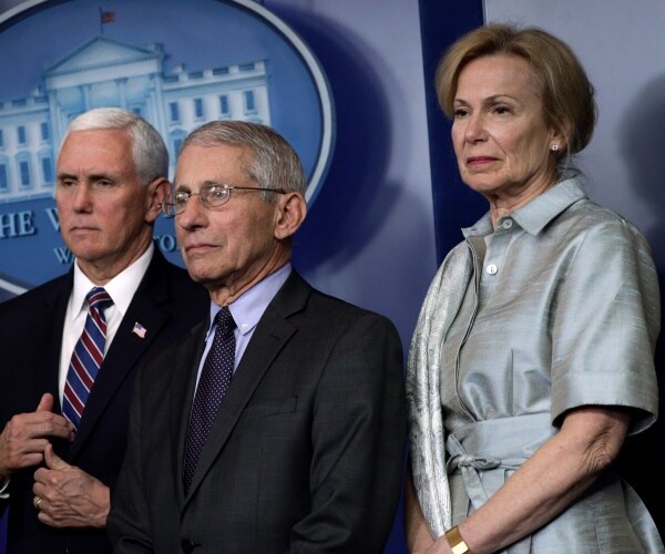 birx in a silver dress pence and fauci stand at a coronavirus press briefing