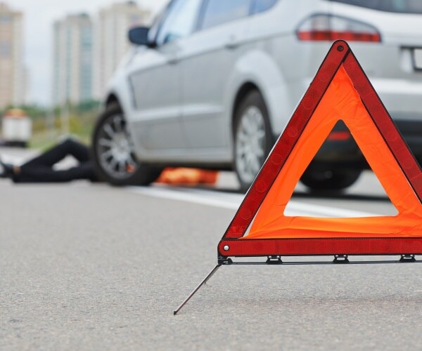 pedestrian on ground in front of van