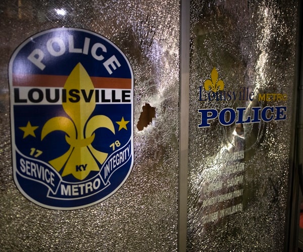 a damaged window at louisville metro police