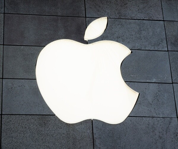 lit up apple logo on a gray building