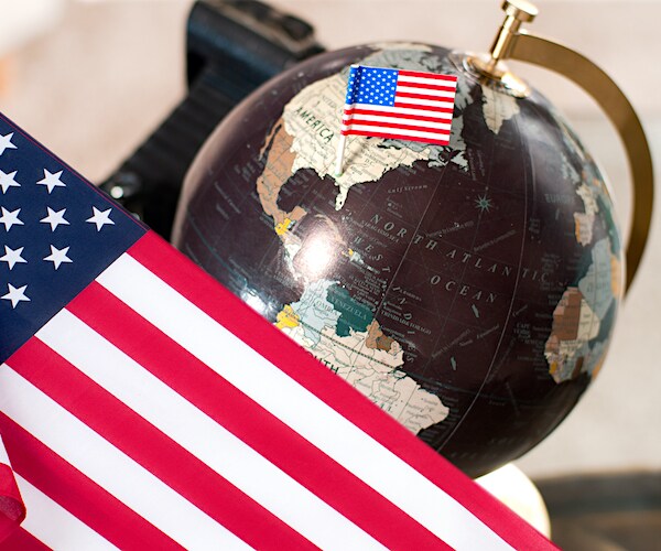 the globe is shown with an american flag stuck in it