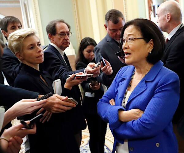 hawaii democratic senator mazir hirono speaks to a throng of reporters