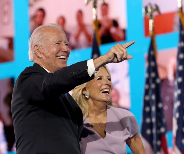 arm in arm joe and jill biden react after his acceptance speech.