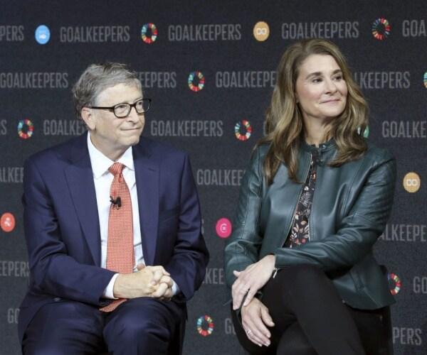 Bill and Melinda Gates speaking on a stage