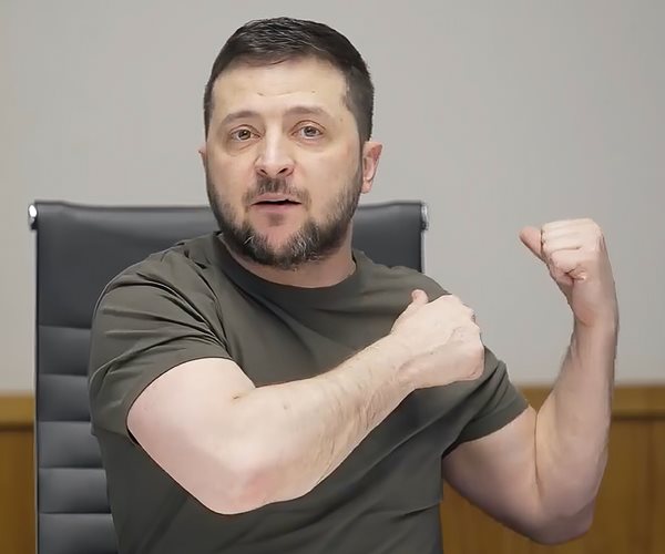 Volodymyr Zelenskyy gestures with both arms in a fighting stance