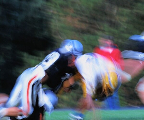 blur of football players tackling