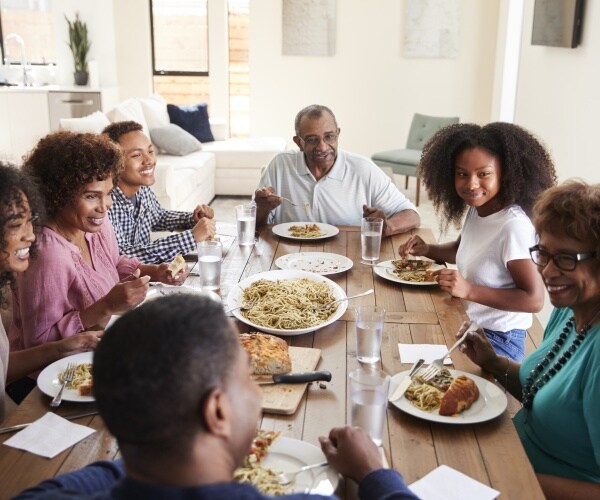 extended family eating dinner at dining room table