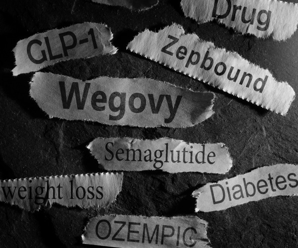 ripped papers with names of weight loss drugs