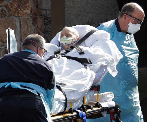 a patient is loaded into an ambulance at the life care center nursing home in kirkland, washington