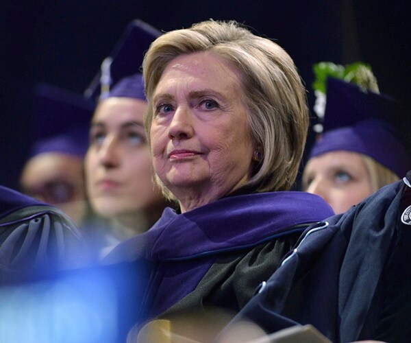 hillary clinton seated at a graduation for hunter college