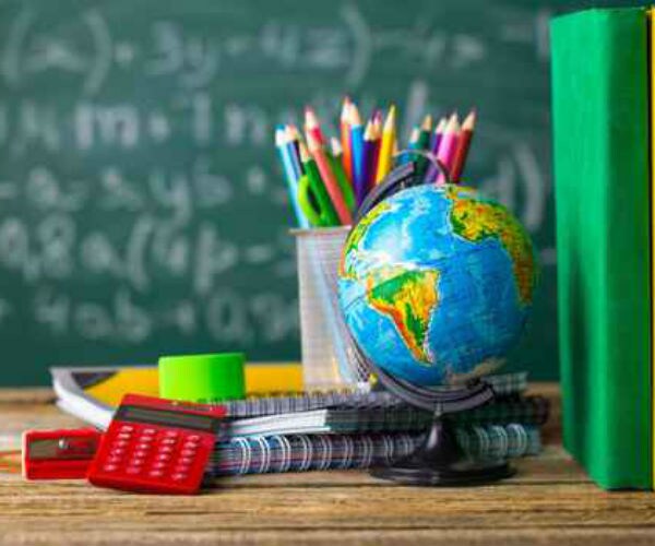 graphic shows a classroom setting with a globe, canister of colored pencils and red calculator