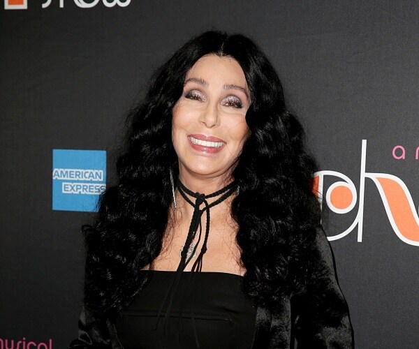 cher in a black outfit with silver eyeshadow