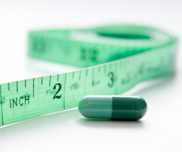 green capsule and measuring tape