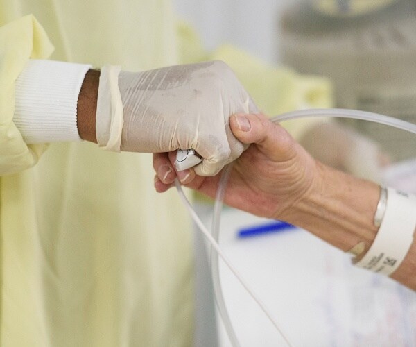 doctor holds patients hand