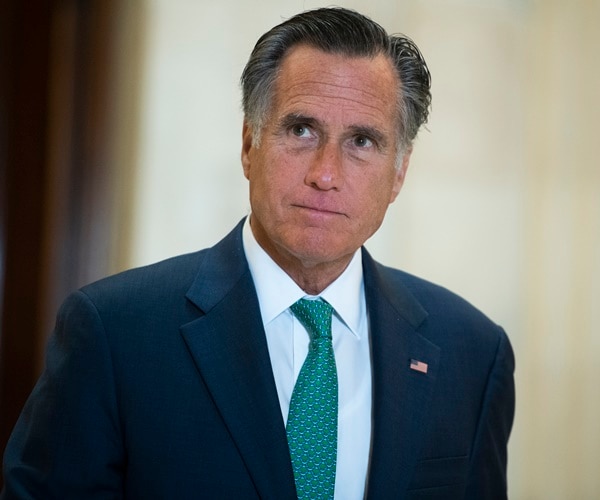 sen. mitt romney walks through halls of congress