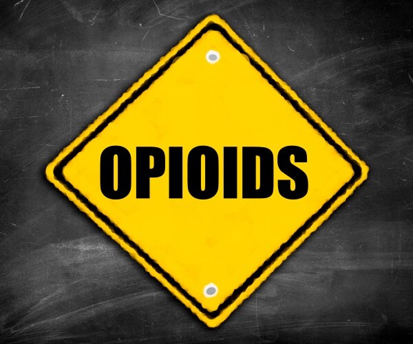 yellow danger road sign says 'opioids'