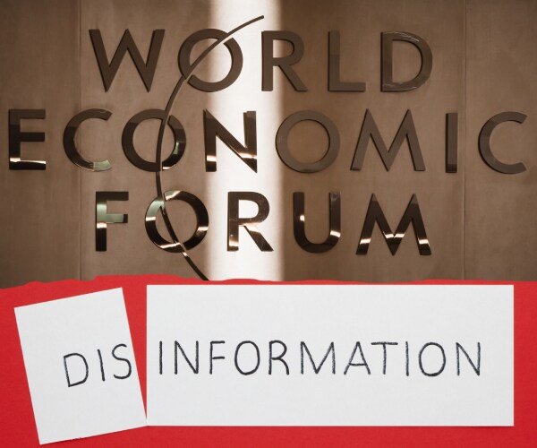 a sign on a door for the world economic forum with disinformation written underneath