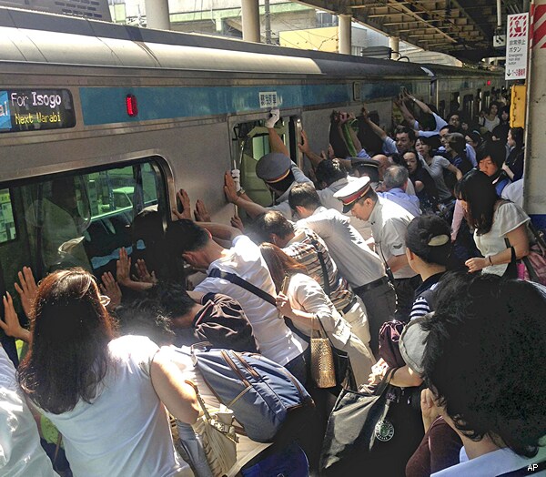 Japanese Commuters Push Train To Save Passenger Trapped by Car